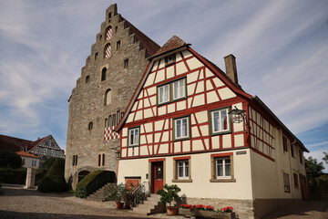Obraz premium Market square in typical German village with Fachwerk houses and big warehouse in summer