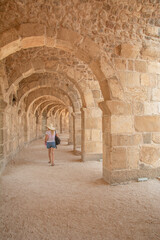 Fototapeta na wymiar Woman tourist visiting The Theatre of Aspendos Ancient City in Antalya