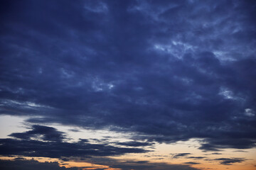 Fototapeta na wymiar Dark stormy sky sunset clouds in summer europe