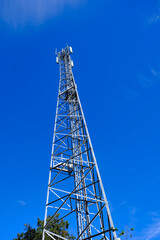 Tall telecommunications tower against a blue sky
