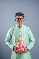 Young Indian man with Lord Ganesha , Celebrating Ganesha festival