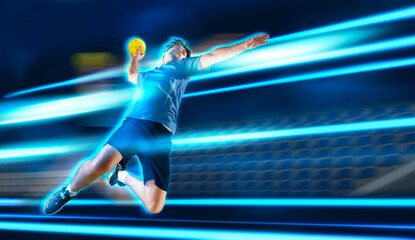 Handball player in action. Blue neon background