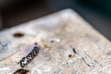 Selective focus on spiral metal shavings left over from drilling metal