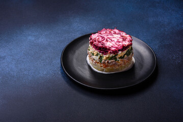 Traditional Ukrainian multilayered salad from herring, beets, potatoes, carrots and eggs