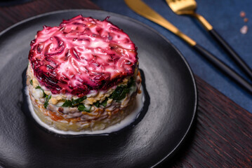 Traditional Ukrainian multilayered salad from herring, beets, potatoes, carrots and eggs