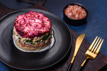 Traditional Ukrainian multilayered salad from herring, beets, potatoes, carrots and eggs