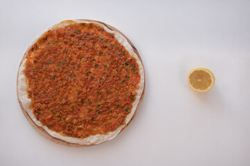 Top view of lahmacun with sliced lemon isolated on white background. homemade fresh turkish food lahmacun