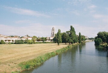 Fototapeta na wymiar The Charente and Cathédrale Saint-Pierre de Saintes, Saintes, Charente-Maritime, Nouvelle-Aquitaine, France.
