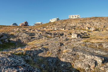 Houses on a rocky ridge in the city of Iqaluit in Nunavut, Canada