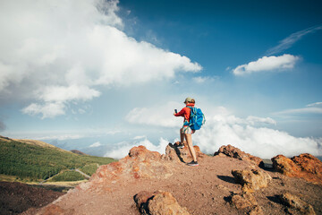Woman hiker taking photo at slopes of Mt. Etna