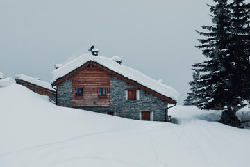 old mountain wooden house in the snow