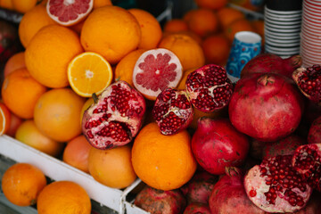 Fresh organic natural juicy food fruits on the market: orange, pomegranate, grapefruit slice