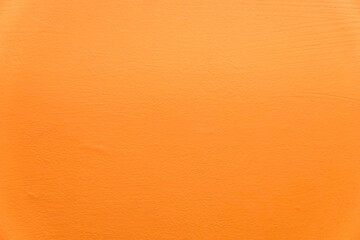 Abstract orange plaster wall texture. Yellow or orange painted plaster cement wall vintage style....