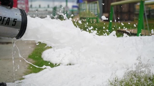 Teaching a team of professional firemen. Close-up fire-extinguishing foam.
