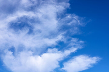 Naklejka na ściany i meble Blue sky with fluffy clouds as a tranquil background