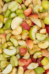 Fresh apples harvest background. Sliced red and yellow apple wedges for a healthy snacks or to make an apple pie, jam, cider or juice outdoors.