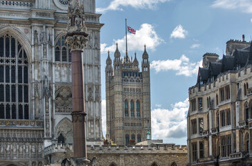 London, UK - September 16, 2022:  Westminster Abbey, Parliament tower with British flag during funeral ceremony of Queen Elizabeth II - obrazy, fototapety, plakaty