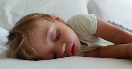 Baby sleeping close-up face. Infant toddler boy asleep dreaming dreaming