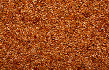 Flax seeds close-up as a background. Flaxseed for replenishment of omega 3 fatty acids. Healthy food for vegetarians.