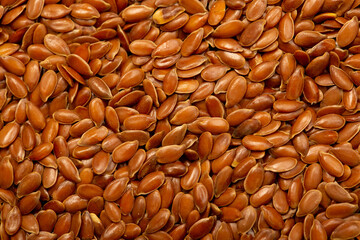 Flax seeds close-up as a background. Flaxseed for replenishment of omega 3 fatty acids. Healthy food for vegetarians.