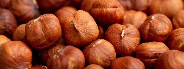 Heap of hazelnuts close-up. Peeled nuts. Hazelnut isolated on white background.