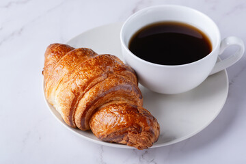 Fresh sweet croissant and coffee for breakfast