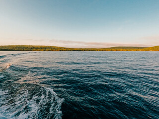 Gliding through the deep blue lake water, taking off from the Northern shore of the Upper Peninsula of Michigan