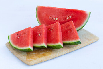 slices of fresh watermelon served on the cutting board. red Watermelon slices on the white table...