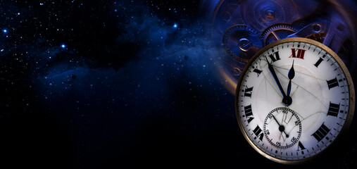 An old antique clock with roman numerals on the dial and clockwork on the night starry sky background