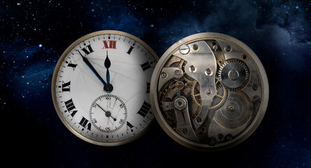 An old antique clock with roman numerals on the dial and closkwork isolated on starry sky background