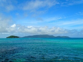 Seychelles, view of Round Island and La Digue Island from the Baie Sainte Anne pier on Praslin Island