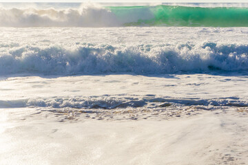 Ocean waves with white foam on a sunny day