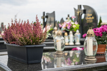 Decoration, candles and flowers on the tombs in cemetery.