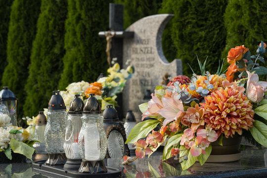 Decoration, candles and flowers on the tombs in cemetery.