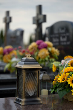 Decoration, candles and flowers on the tombs in cemetery.