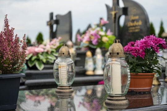 Decoration, candles and flowers on the tombs in cemetery.