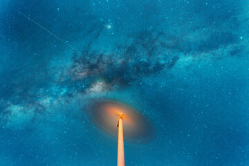 Fototapeta premium night sky over a spinning wind turbine, long exposure.
