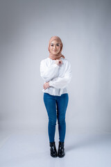 Fototapeta na wymiar Portrait of a beautiful female Muslim model wearing hijab, a lifestyle apparel for Muslim women isolated on white background. Modern hijab fashion concept.
