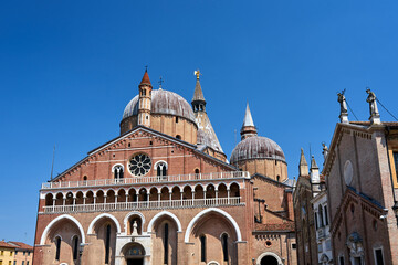 Fototapeta na wymiar The facade, domes and towers of the medieval church of St. Anthony in the city of Padua