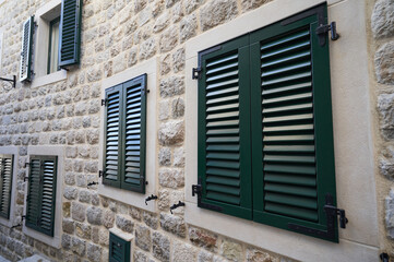 External green plastic shutters on windows, home improvement concept