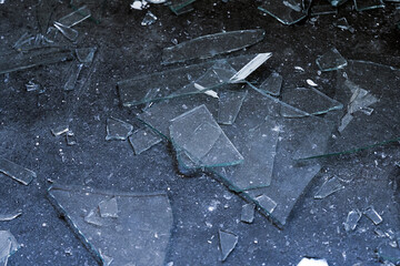Broken glass dark background. Monochrome background with glass pieces