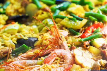 Traditional spanish rice paella with seafood, shrimp close-up,