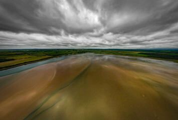 Clouds over the Cefni Estuary and the village of Malltraeth, Anglesey, Wales. Aerial view