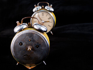Old and analog iron alarm clock in the dark