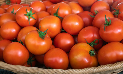 Close up of fresh red tomatoes in a basket at the market