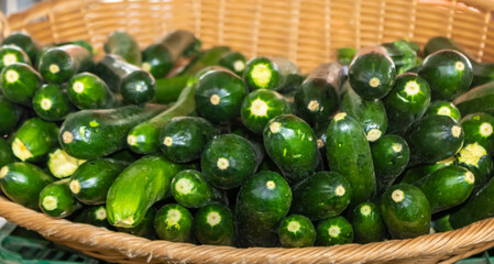 Close up of fresh cucumbers in a basket at the market