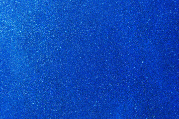 Background with sparkles. Backdrop with glitter. Shiny textured surface. Strong blue