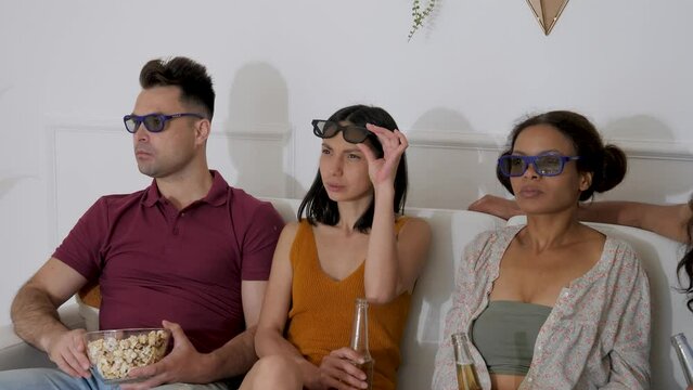 two guys and 2 girls look in 3d glasses and react to what they see