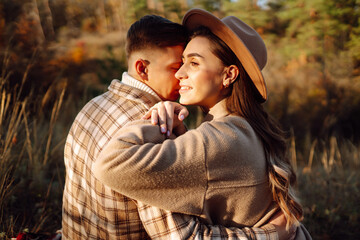 Young couple in love walking in the park on a autumn day. Enjoying time together.
