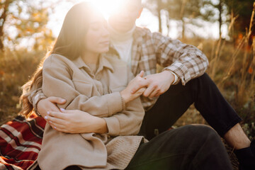 Young couple in love walking in the park on a autumn day. Enjoying time together.